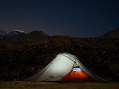 An illuminated tent at night in the mountain. Photo by Dan Maus/BLM.
