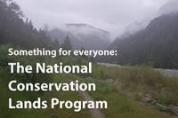 Trail by river. Low clouds over mountains in the distance. "Something For Everyone: The National Conservation Lands Program"