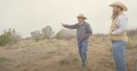 Rancher Mike Corn pointing out at the mesquite bushes in the the grasslands on his ranch.